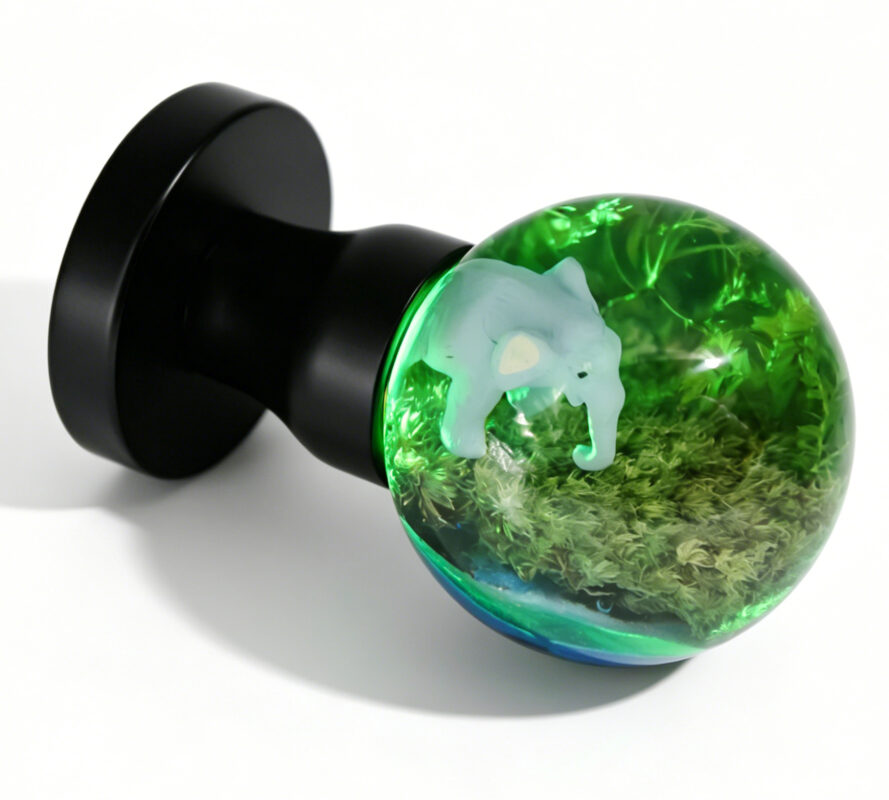 The Story Behind SunKnob’s Fantasy Creations Elephant-Themed Resin Door Handle Emitting Cyan Light, Mounted on a Round Black Brass Base