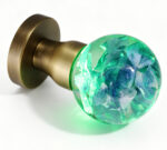 Handcrafted Hydrangea Resin Door Knob Emitting a Cyan Glow, Mounted on a Round, Copper-Toned Brass Base