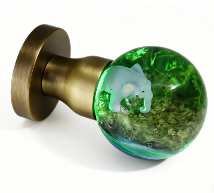 Elephant-Themed Resin Door Handle with Green Illumination Elephant-Themed Resin Door Knob with Green Illumination, Mounted on a Round, Copper-Toned Brass Base