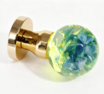 Handcrafted resin door knob featuring hydrangeas that emit a warm yellow glow, mounted on a round gold-tone brass base.