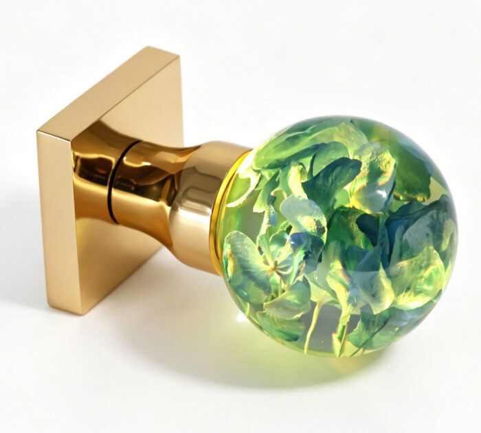 Elephant-shaped resin door handle with warm yellow lighting-1 Handcrafted resin door knob featuring hydrangeas and emitting a warm yellow glow, mounted on a square gold-tone brass base.