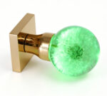 Dandelion Resin Door Knob Emitting Green Light, Mounted on a Square Gold Brass Base